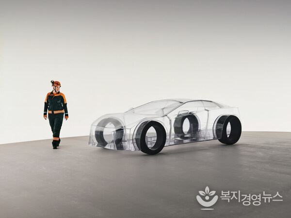 A dedicated Sandvik engineer walks around the eNimon, assessing the eNimon, which highlights the critical, often unseen, reliance on robust mining infrastructure to power the EV future.